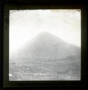 LDGSL/1088/AC/GB/22Black and white photograph of an unknown hill feature, by Ananda Kentish Coomaraswamy, [1890s-1900s].  It could be of an extinct volcano, perhaps from the Auvergne region of France as there are 11 other slides taken by Coomaraswamy in this area.