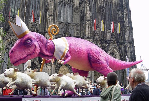 A sculpture of a dinosaur and sheeps (10 meters long and 4 meters tall) as criticism of the church/pope/WJT