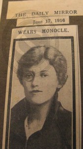 Top part of newspaper cutting showing Elsie Burrell wearing a monocle, 1916