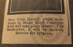 Bottom part of newspaper cutting showing Elsie Burrell wearing a monocle, 1916